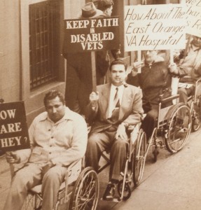 Founding member Robert Moss (with pipe) leads a 1948 demonstration at Grand Central Terminal, New York City, for improved health care for paralyzed veterans.